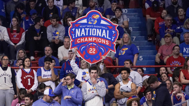 Feb 25, 2023; Lawrence, Kansas, USA; A Kansas Jayhawks fan holds up a National Champions sign against the West Virginia Mountaineers during the second half at Allen Fieldhouse. Mandatory Credit: Denny Medley-USA TODAY Sports